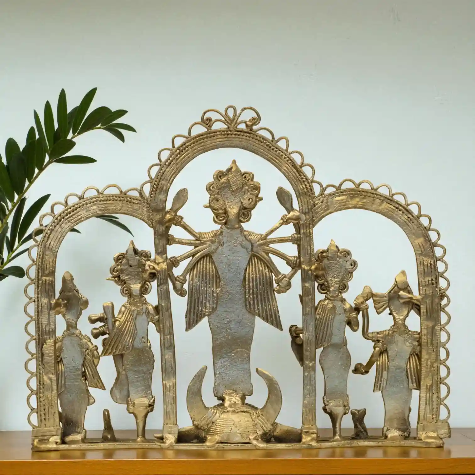 Back view of folk dokra Durga idol showing handcrafted metal design.
